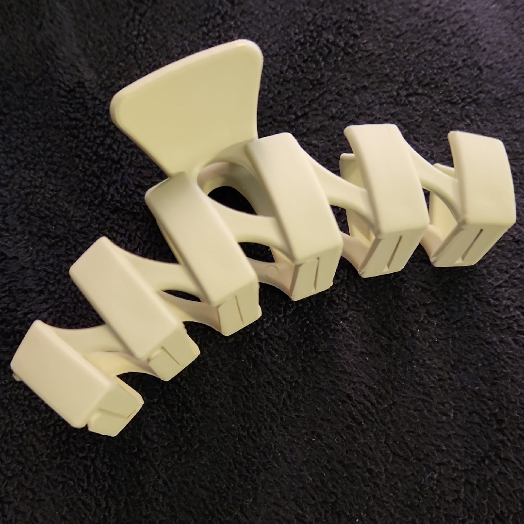 A moulded plastic hair claw clip photographed against a plain background